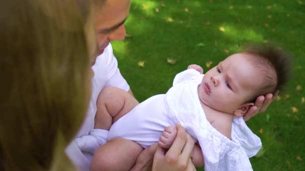Happy parents watching their cute baby outdoors — Stock Video