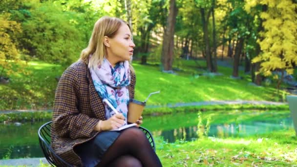 Jovem mulher de negócios confiante trabalhando em belo parque — Vídeo de Stock