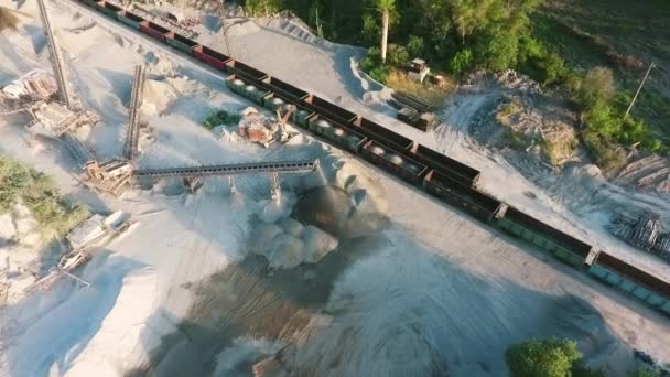 Aerial of transportation carriages loaded with minerals from granite quarry — Stock Video