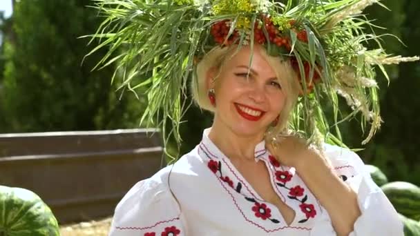 Vidám női modell virágos körökben pózol betakarított görögdinnyével — Stock videók