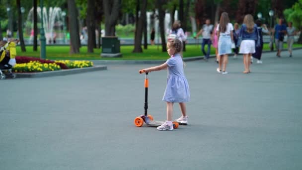 Little Girl Braids Wearing Dress Standing Scooter Public Park Cute — Stock Video