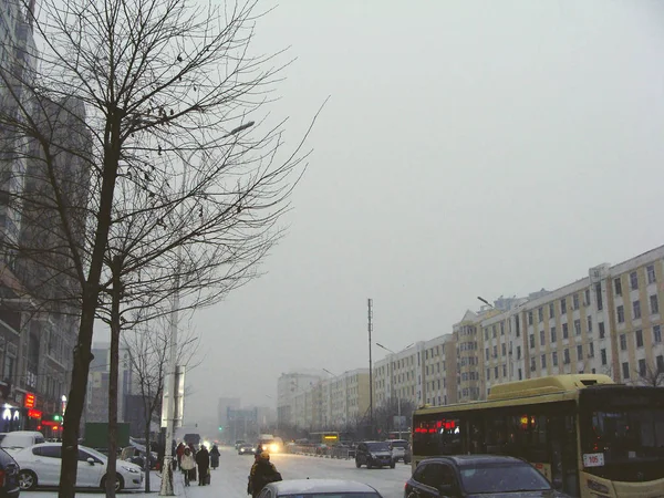 Zasněžený večer ve městě. Město vozovky v zimní večer. — Stock fotografie