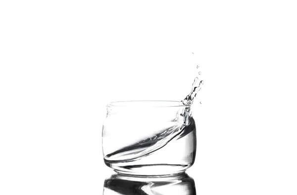 Splash of water in a glass cup on a white background — Stock Photo, Image