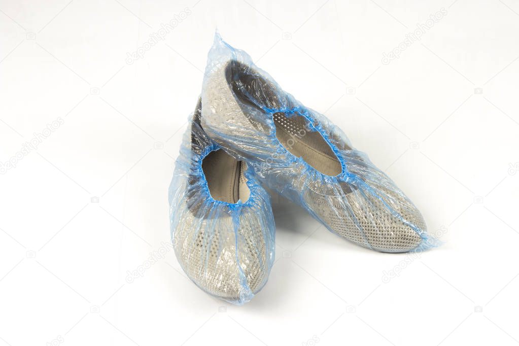 Women's shoes in blue shoe covers on a white background, isolate