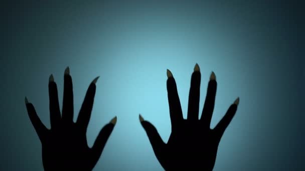 Hands of evil creature with sharp nails beating on glass, evil witch in lockup — Stock Video