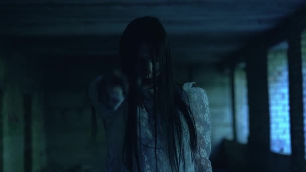 Психованная мертвая невеста держит жуткую руку в темноте, пытаясь поймать жертву — стоковое видео