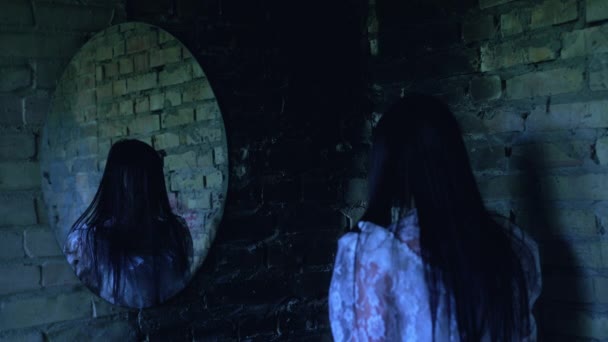 Reflection of creepy woman disappearing in mirror, lost soul walking away — Stock Video