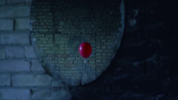 Zrcadlový odraz jediného červeného balónu objevujícího se na podivném opuštěném místě — Stock video