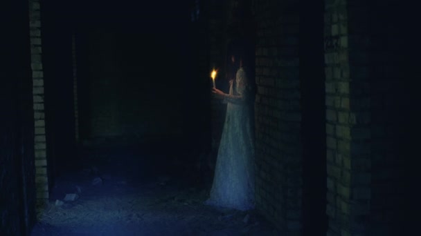 Ghost of dead woman wandering old house with burning candle, horror thriller — Stock Video