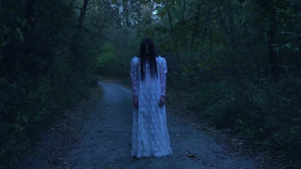 Creepy dead bride wandering alone in mysterious night forest, horror story — Stock Video