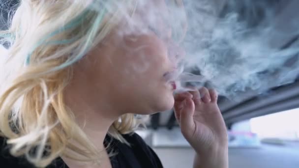 Lázadó tinédzser lány cigarettát gyújt, a szabályok elleni tiltakozásként dohányzik.