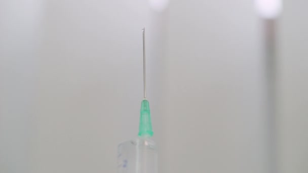 Liquid medicine dripping from syringe needle close-up, vaccination campaign — Stock Video