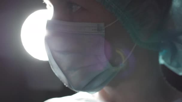 Overworked surgeon operating patient to save life, wiping forehead, occupation — Stock Video