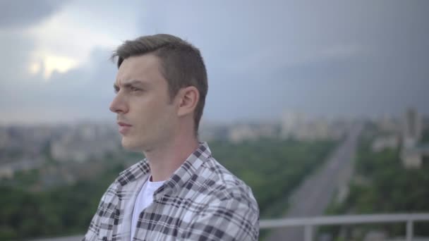 Worried young man standing on rooftop, thinking of problems, negative emotions — Stock Video