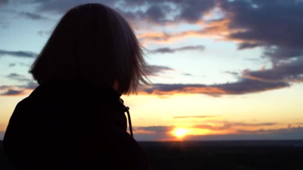 Droevige vrouw kijkt naar zonsondergang, denkt aan problemen, hoopt op veranderingen — Stockvideo