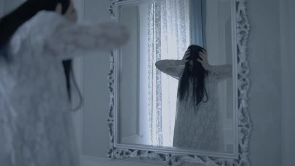 Hátborzongató fiatal nő, megszállott ördög a tükör előtt, titokzatos özvegy. — Stock videók
