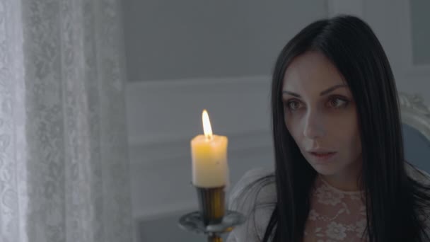 Mago femmina che dice incantesimo, guarda la candela, rituale della magia nera — Video Stock