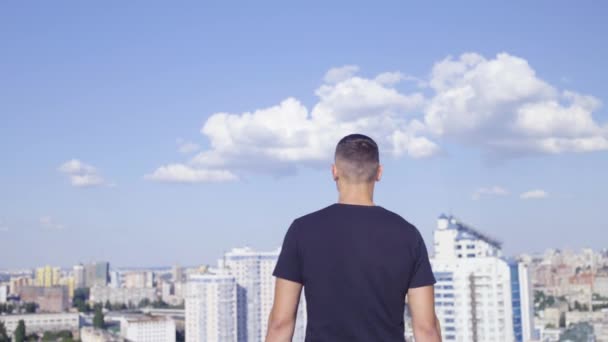 Young man raising hands up, standing of the rooftop, feeling free, achievement — Stock Video