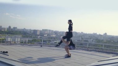 Manga yapan bir adam, kız arkadaşını omuzlarında tutan, tüm vücudunu ağırlık ile çalıştıran bir adam.