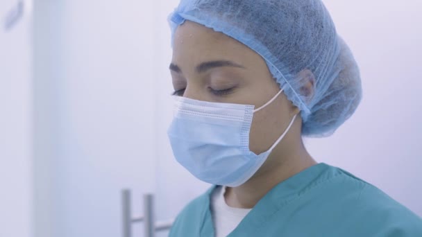 Terli siyah kadın doktor alnını siliyor, stresli işten, tükenmiş — Stok video