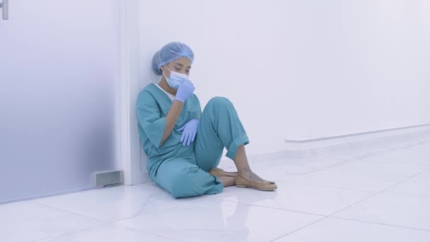 Smutná sestra sedící na nemocničním patře, přestávka během dlouhé směny, propuknutí nemoci — Stock video