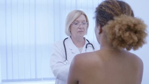 Μαστολόγος που εξετάζει νεαρή γυναίκα ασθενή, πρόληψη καρκίνου του μαστού, εξέταση — Αρχείο Βίντεο