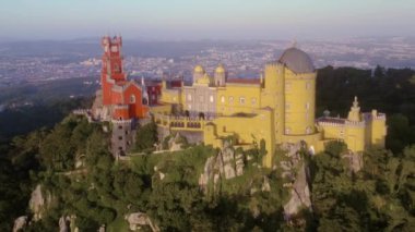 Günbatımında Sintra 'daki Pena Sarayı, Portekiz, 4k hava aracı manzaralı.