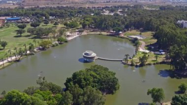 İsrail 'deki Leumi parkının üzerinde Tel Aviv iş ufuk çizgisini uzaktan gören 4k hava aracı görüntüleriyle uçuyor.