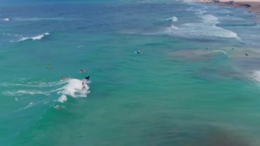 Sıcak bir yaz gününde denizdeki sörfçüler, hava aracı görüntüsü, yavaş çekim 4k