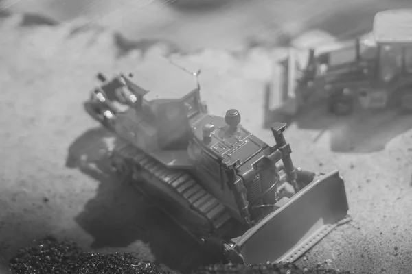 Toy tractor in the scenery of coal mining — Stock Photo, Image