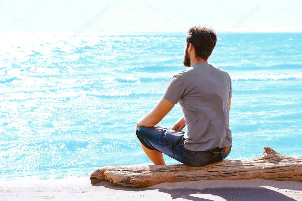 a man sitting on the beach