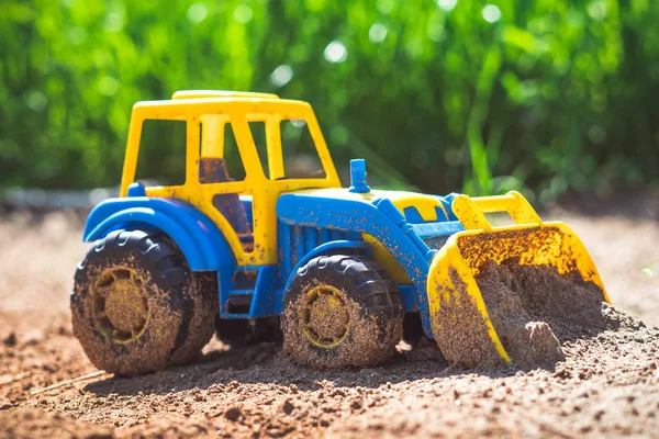 Toy tractor in the sand — Stock Photo, Image