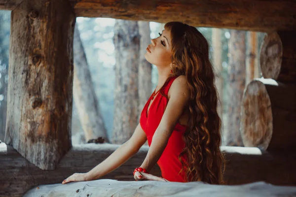 Woman in dress wooden house — Stock Photo, Image