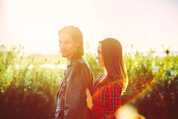 Pareja de pie en la puesta del sol — Foto de Stock