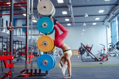 spor salonunda kız ve elleri üzerinde duran