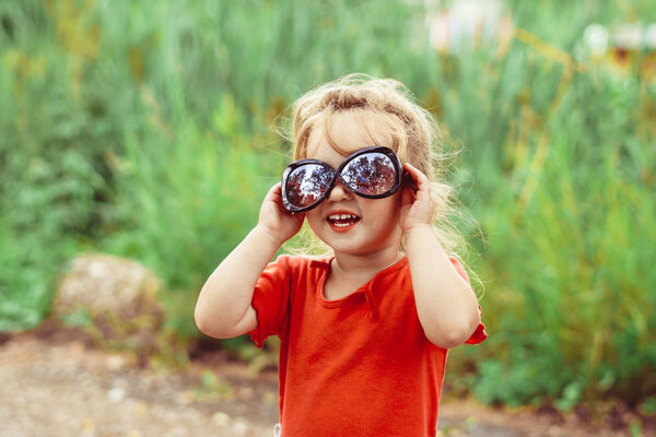 little girl in sunglasses smiling