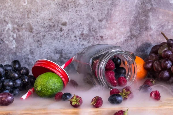 Frutas em forma de frasco de smoothie. Uvas, framboesa, lima, fundo escuro — Fotografia de Stock