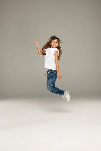 Happy Jumping Young Girl Stock Photo