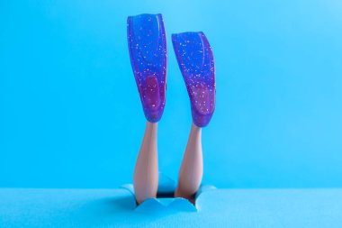 Şnorkel yüzgeçler mavi deniz arka plan en az yaratıcı soyut kavram üzerinde bebek bacakları.