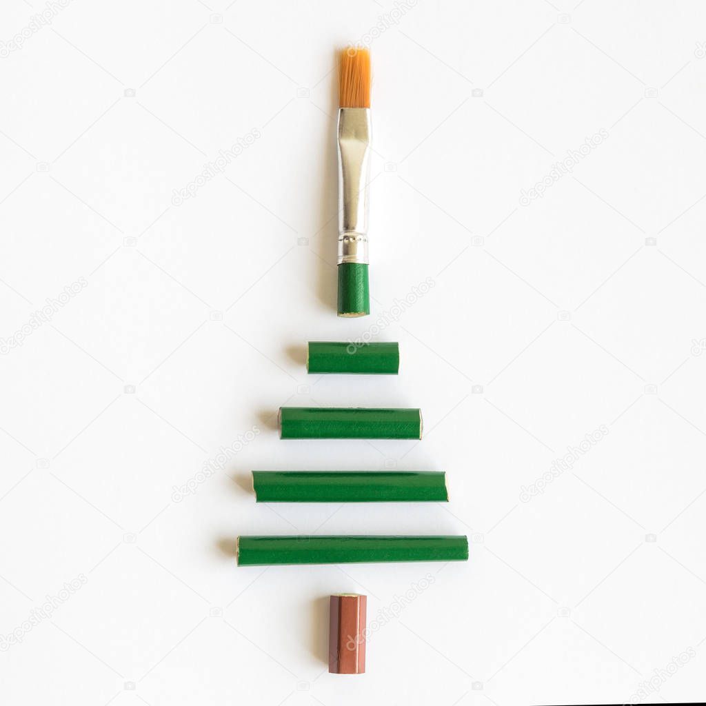 Christmas tree made of art paint brush on bright background minimal creative holiday concept.