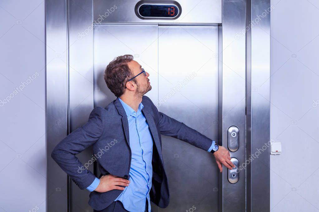 Businessman calling the elevator