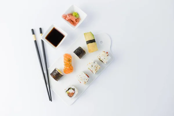 Flat lay of of japanese sushi set on white background. Space for copy.