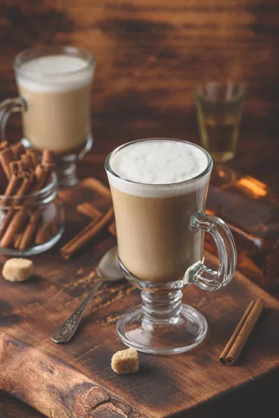 Coffee with Irish whiskey and whipped cream in glass