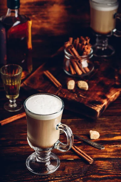 Coffee with Irish whiskey and whipped cream in glass