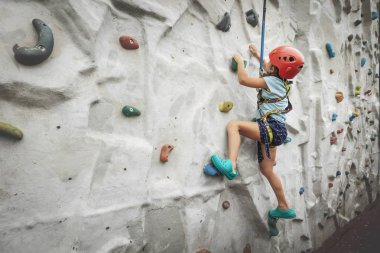 The child learns climbing. Climbing Wall. clipart