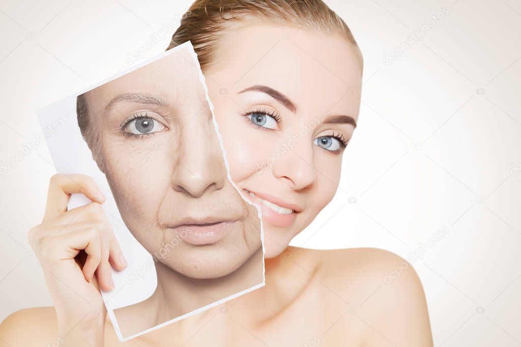 closeup portrait of young woman face holding portrait with old wrinkled face