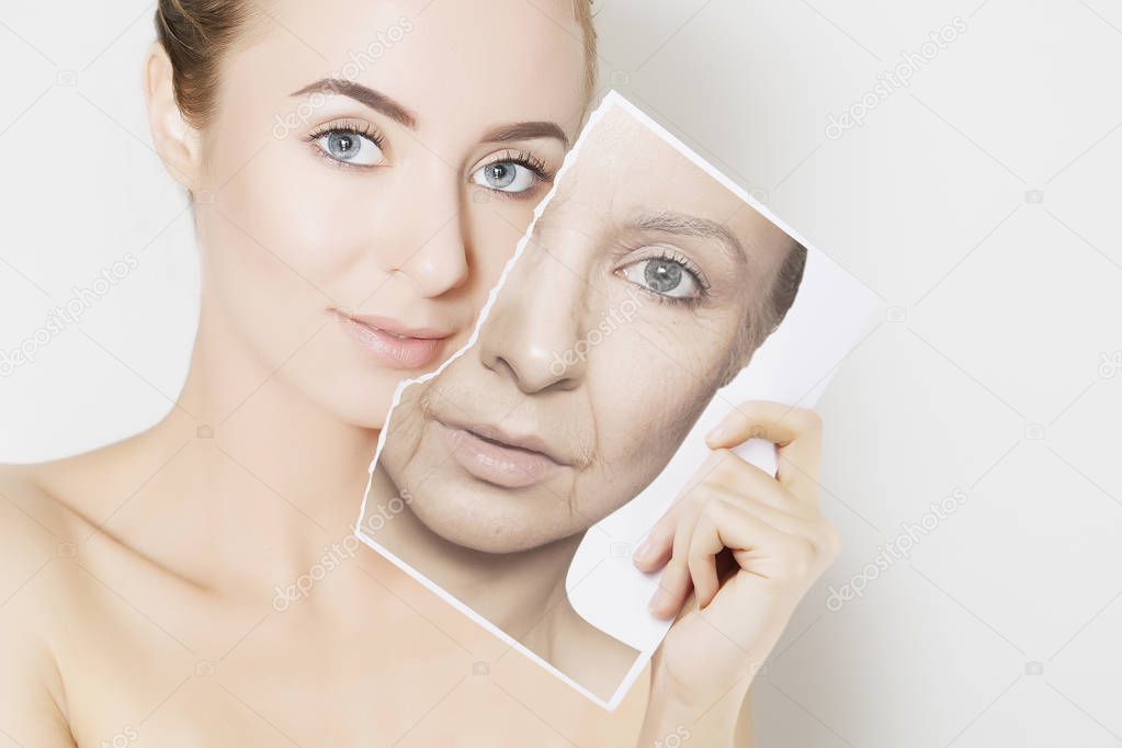 closeup portrait of young woman face holding portrait with old wrinkled face
