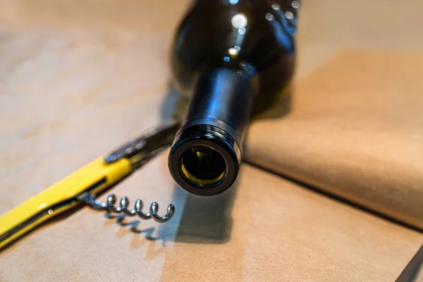 Wine and corkscrew on old paper background — 스톡 사진