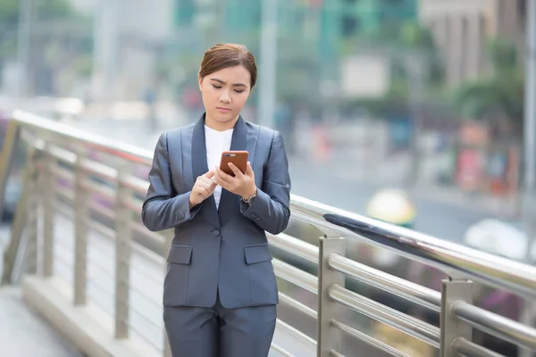 Woman typing the smartphone and she feel sad — Stock Photo, Image
