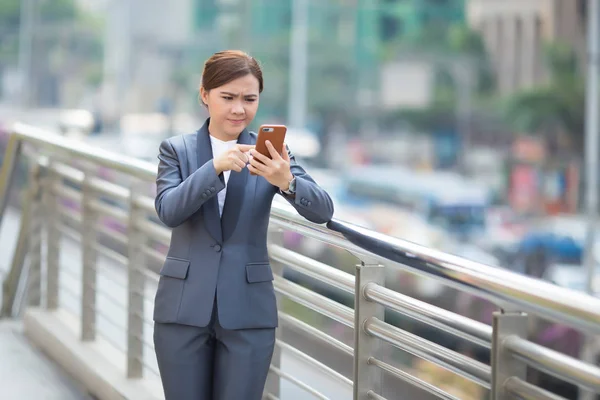 Woman typing the smartphone and she feel angry — Stock Photo, Image